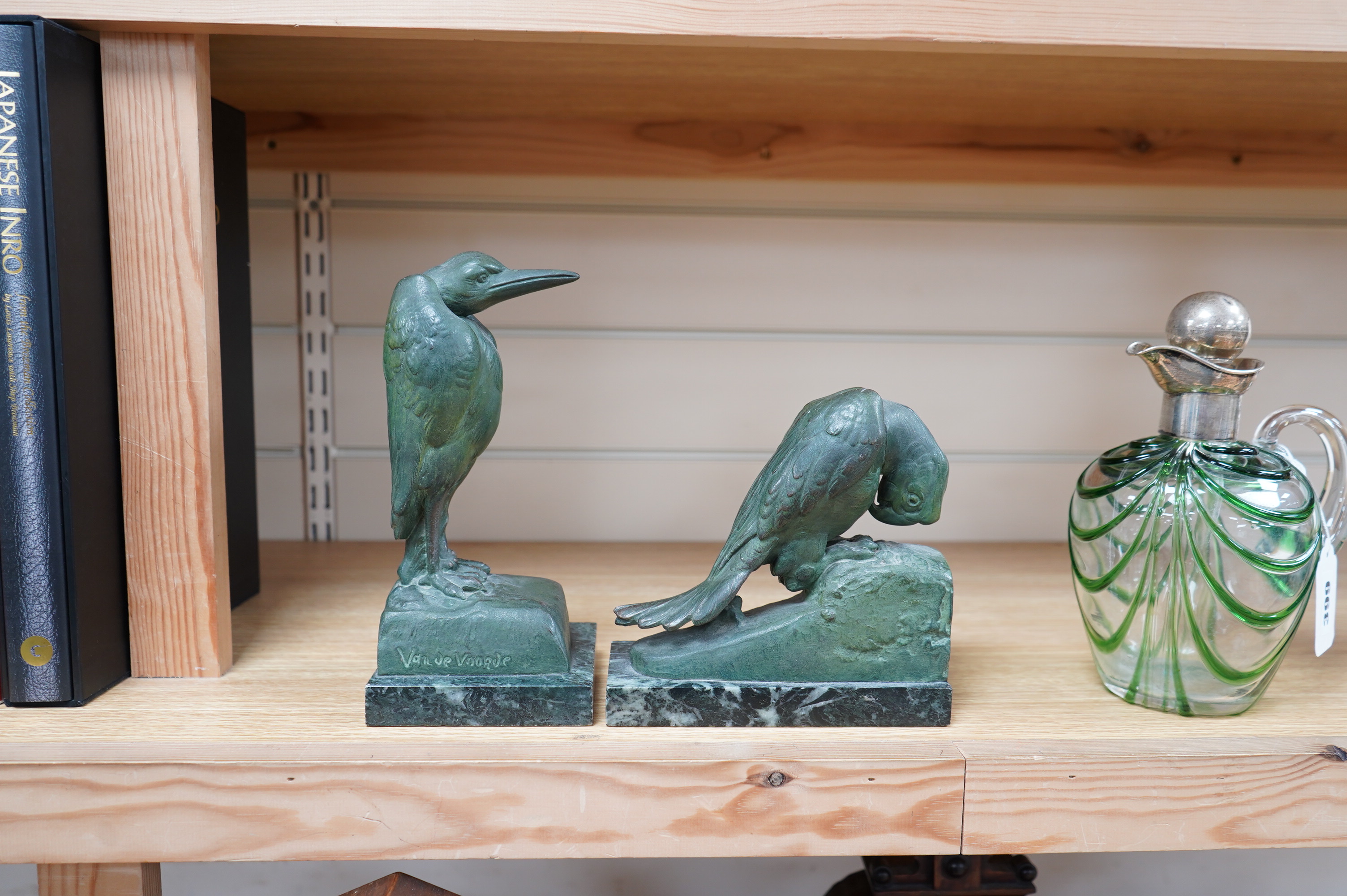 Georges Van de Voorde (Belgian 1878-1970). A pair of Art Deco bronzed spelter bookends modelled as a parrot and stork, on marble plinths, tallest 21.5cm. Condition - fair to good.